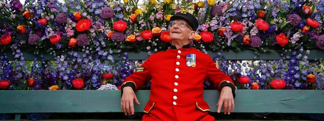 A shopfront dressed with a large floral installation during a London flower festival
