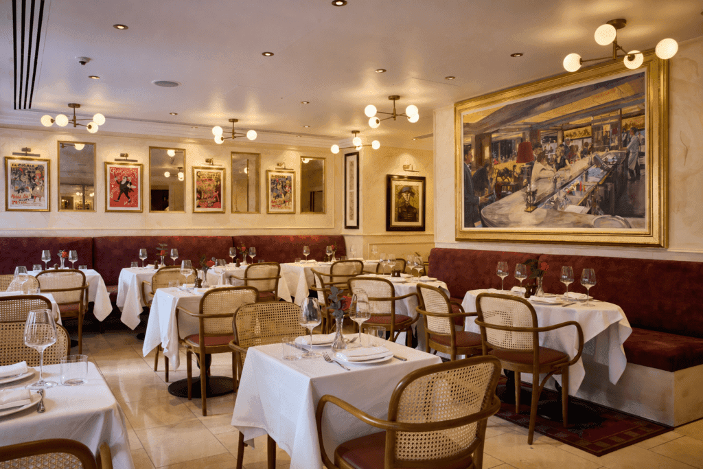 A classic Parisian style bistro interior with a corner bar and banquettes
