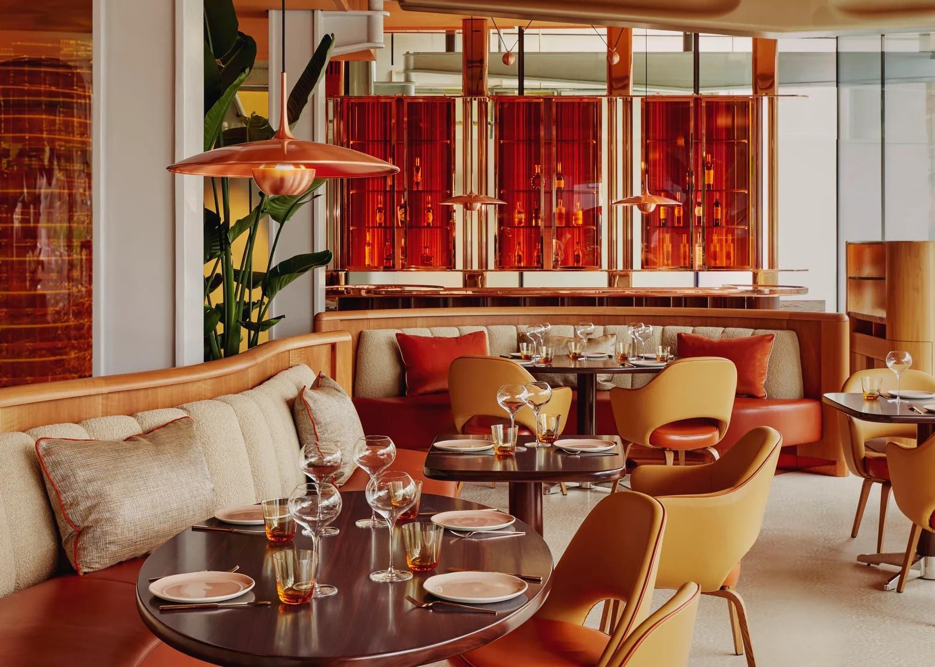A brunch table with pancakes, pizza and cocktails in bright daylight